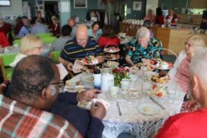 Photos of guests enjoying afternoon tea and students from Canterbury College and Barton Court